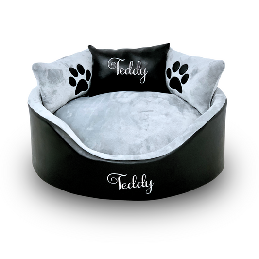 Soft black leather and silver dog and cat bed with personalised name embroidery, providing comfort and style for your pet.