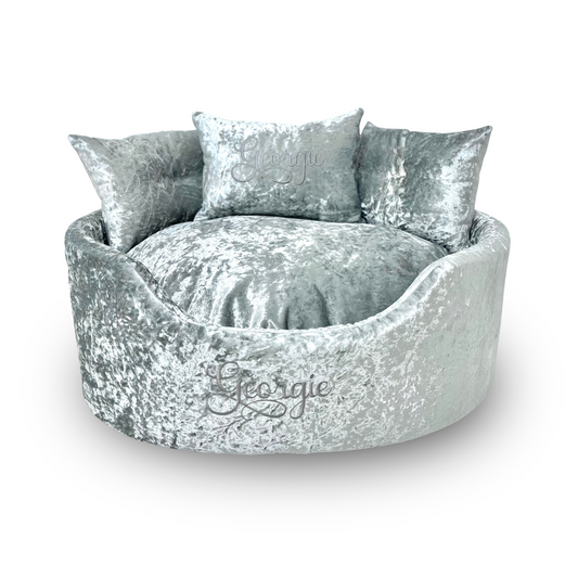 Soft silver crushed velvet dog and cat bed with personalised name embroidery, providing comfort and style for your pet.