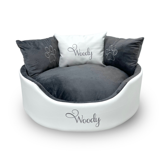 Soft white leather and grey dog and cat bed with personalised name embroidery, providing comfort and style for your pet.
