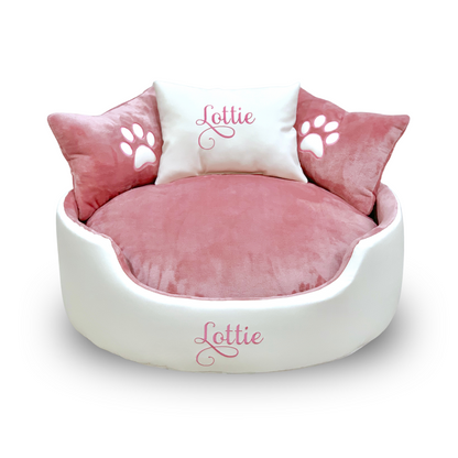 Soft white leather and pink dog and cat bed with personalised name embroidery, providing comfort and style for your pet.