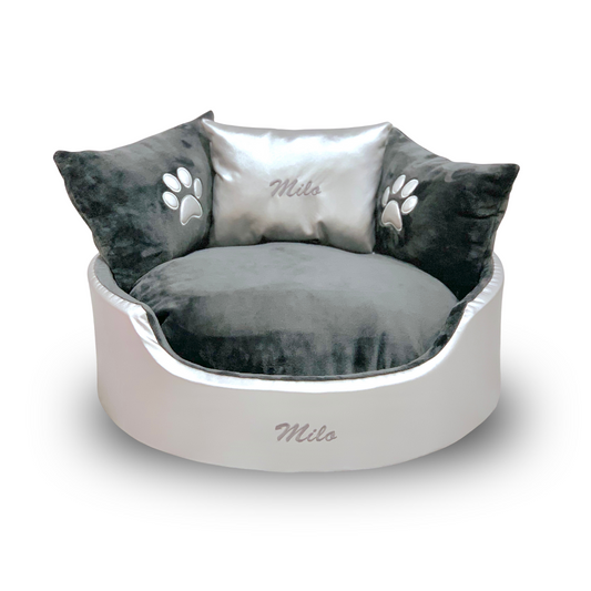 Soft silver leather and grey dog and cat bed with personalised name embroidery, providing comfort and style for your pet.